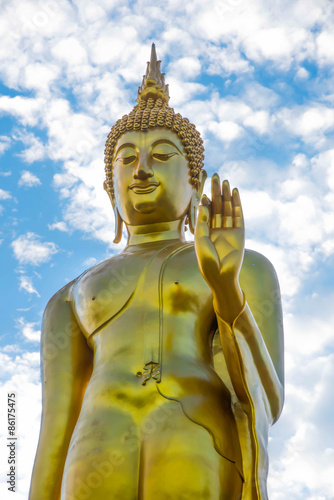 Golden Buddha statue  over blue sky Tak Thailand