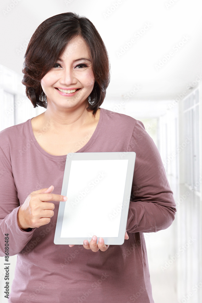 Woman holding and showing tablet computer Woman holding and showing tablet computer