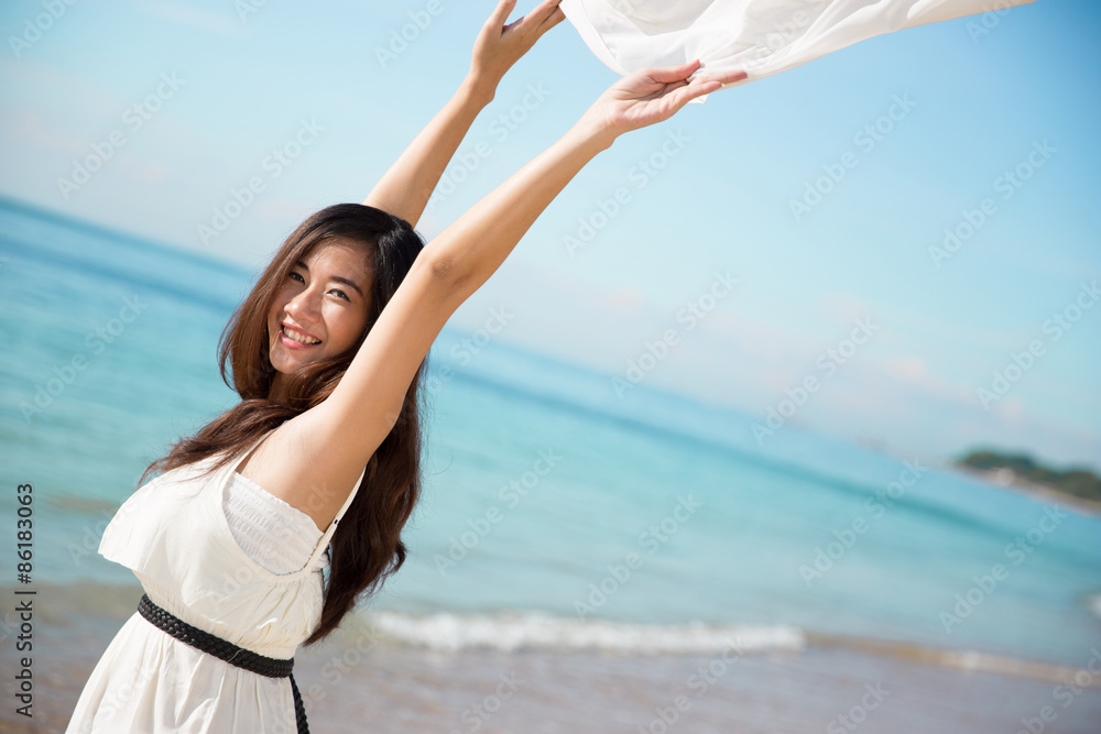 Asian woman enjoying the beach with open arms Asian woman enjoying the beach with open arms