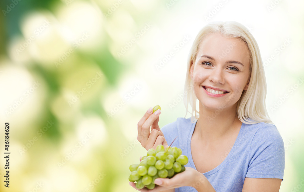 happy woman eating grapes