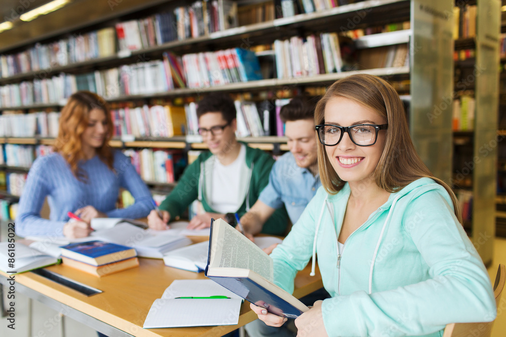 happy students reading books in library happy students reading books in library