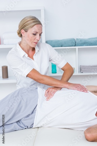 Doctor examining her patient back