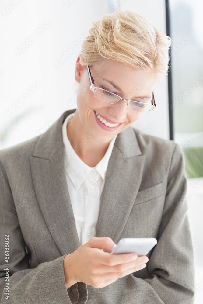 Businesswoman using her smartphone Businesswoman using her smartphone