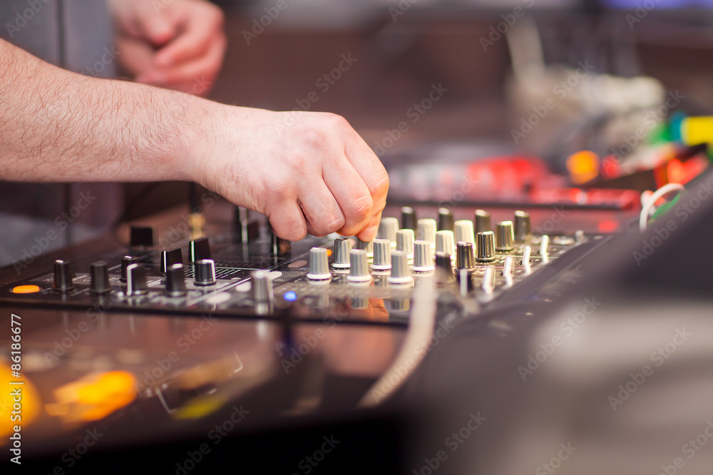 Fototapeta premium DJ mixing music on console