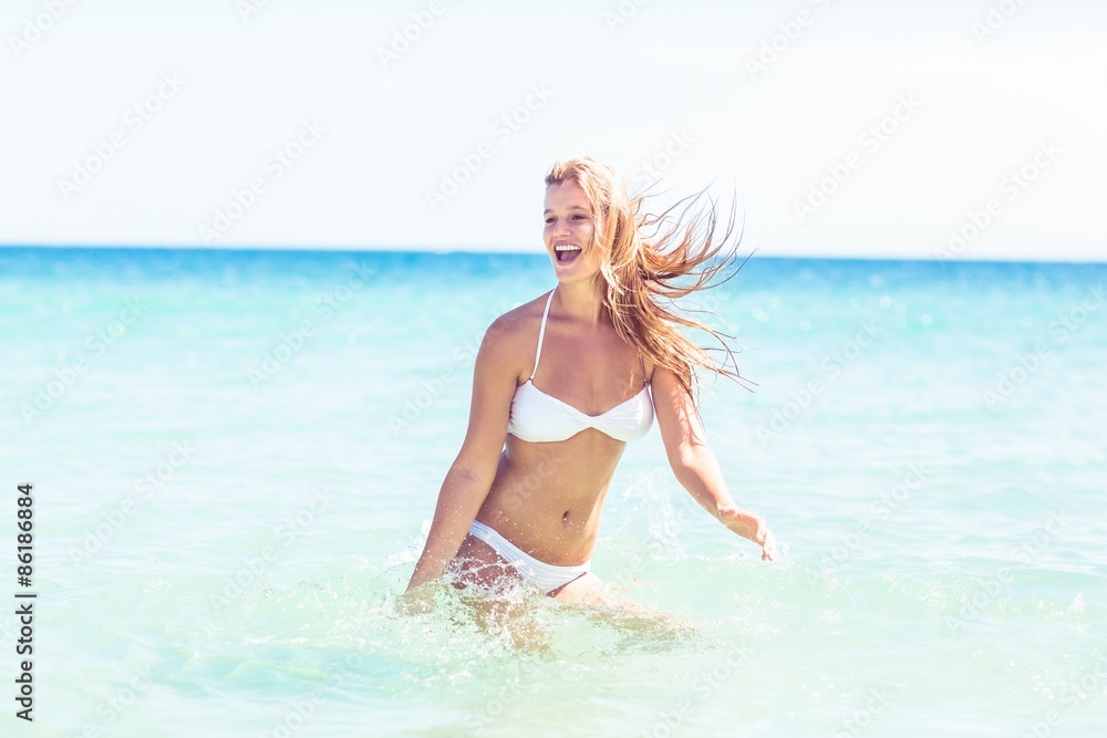 Happy pretty blonde bathing into the sea 