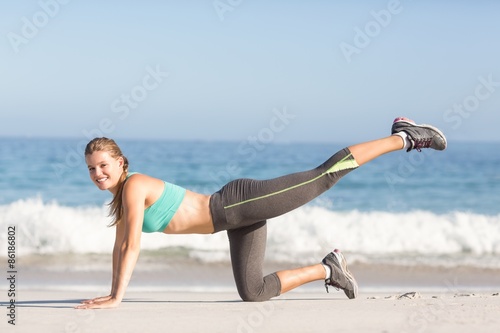 Fit woman stretching her leg 