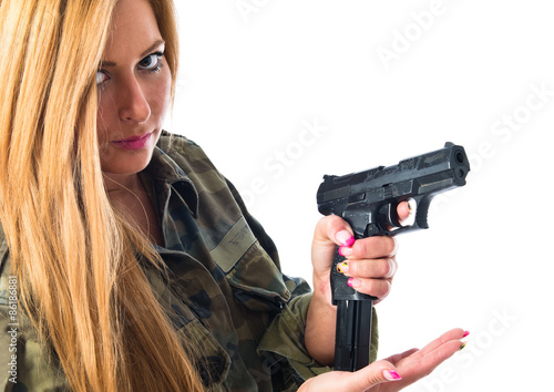 Military woman carrying a gun
