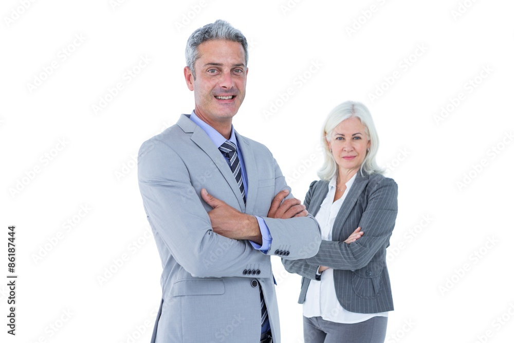 Smiling businesswoman and man with arms crossed Smiling businesswoman and man with arms crossed