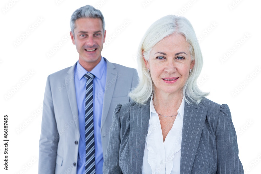 businessman and businesswoman smiling at the camera businessman and businesswoman smiling at the camera