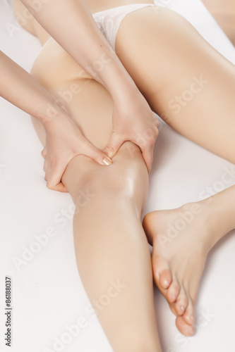 massaging the acupressure points on the woman s thigh