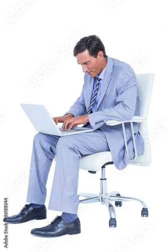 Handsome businessman sitting on a swivel chair 