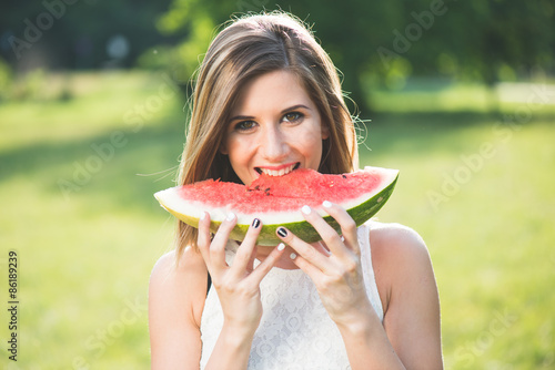Beautiful girl eating fresh watermelon
