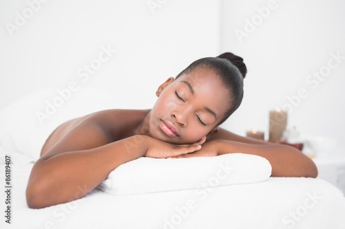 Peaceful pretty woman lying on massage table 