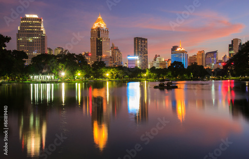 Business district cityscape from a park with Twilight Time from Lumpini Park  Bangkok  Thailand