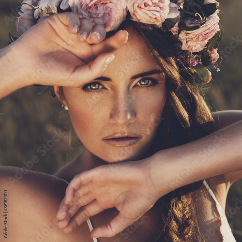 Portrait of young woman with circlet of flowers on head