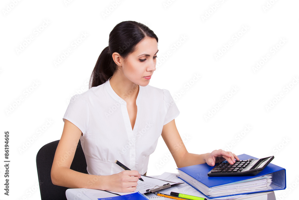Young business woman working at office, writing and calculating Young business woman working at office, writing and calculating