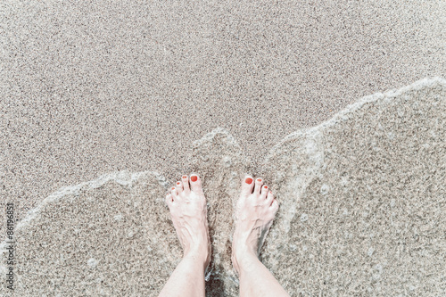 Retro Effect Of Sea Waves And Girl Feet On Summer Sand Beach