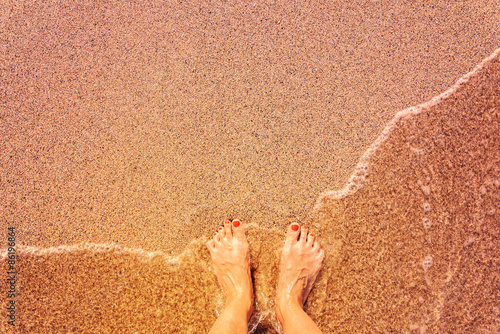 Retro Effect Of Sea Waves And Girl Feet On Summer Sand Beach