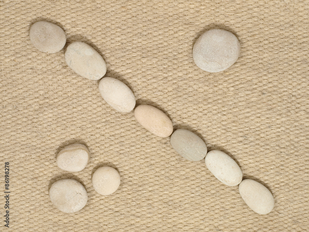 Row of small stones on fiber background. Row of small stones on fiber background.