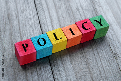 word policy on colorful wooden cubes photo