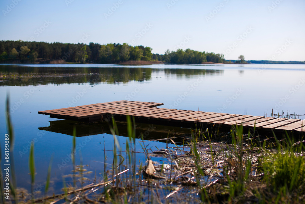 Pier for fishing boats on shore of lake Pier for fishing boats on shore of lake