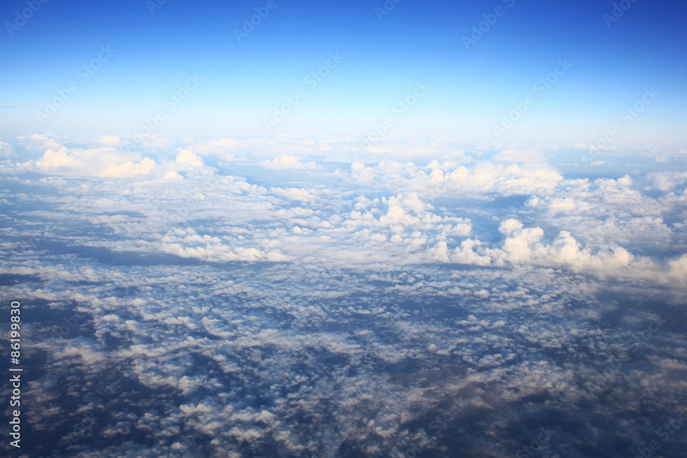 Fototapeta premium view from the bird's-eye view of the airplane window at the horizon and clouds