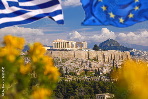 Fototapeta Naklejka Na Ścianę i Meble -  Acropolis with flag of Greece and flag of European Union in Athens, Greece