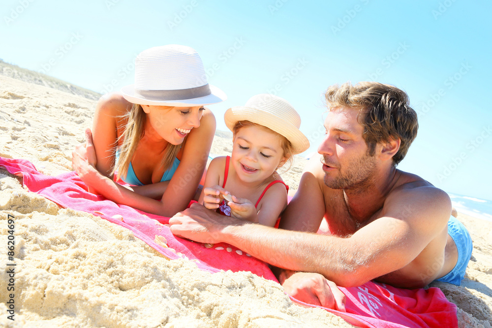 Family playing with seashells on the beach Family playing with seashells on the beach