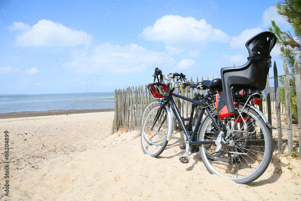 Fototapeta premium Bicycles leaning on fence by the beach