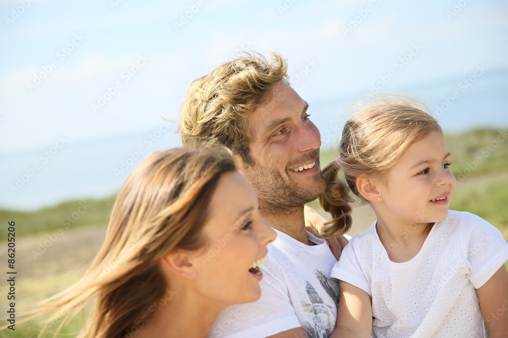 Portrait of happy family walking together in natural landscape Portrait of happy family walking together in natural landscape