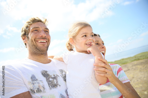 Portrait of happy family walking together in natural landscape