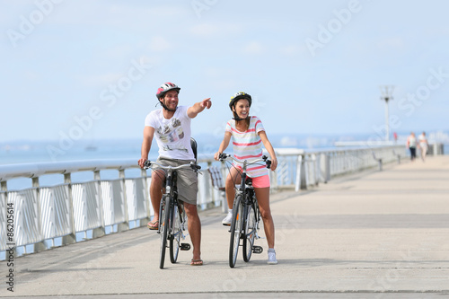 Family on a biking journey by the sea © goodluz