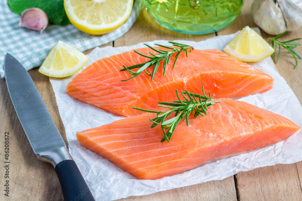 Fresh raw salmon fillet with rosemary and lemon Fresh raw salmon fillet with rosemary and lemon