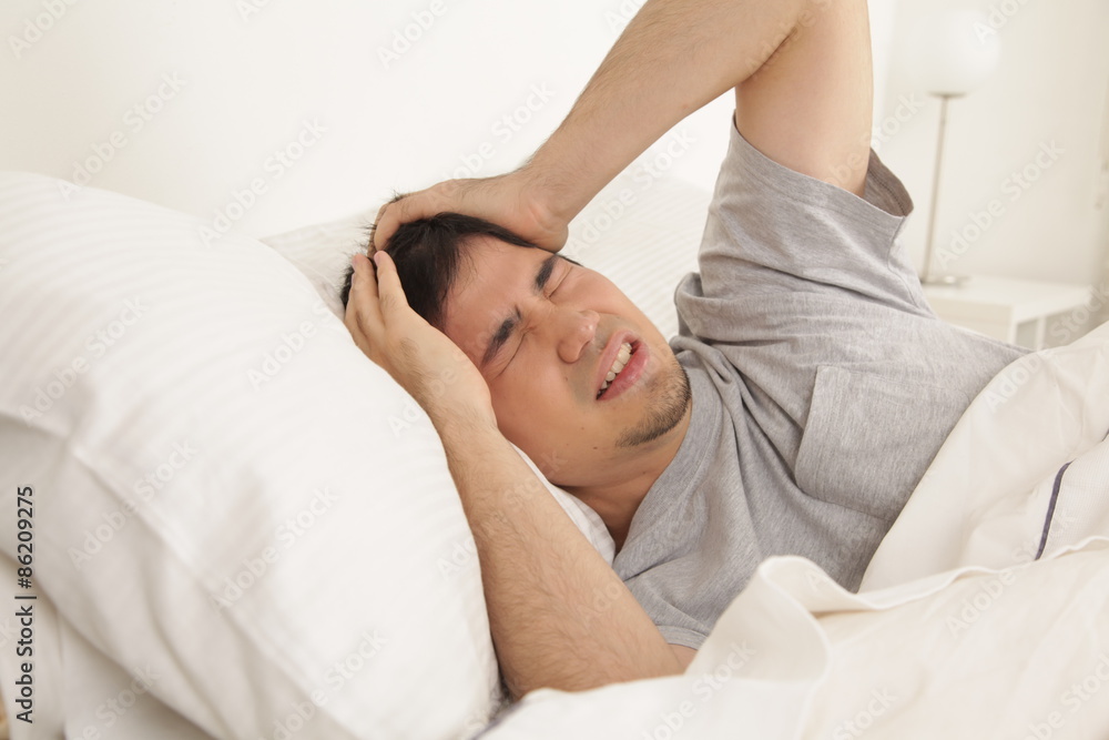Fototapeta premium Man waking up with headache