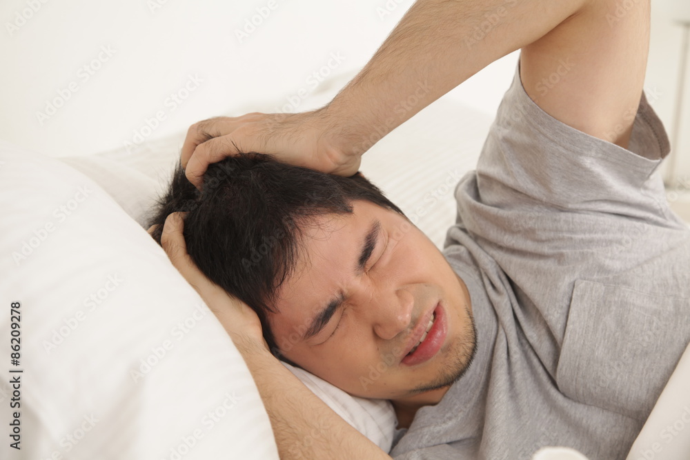 Man waking up with headache