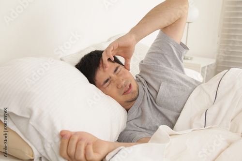Man waking up with headache