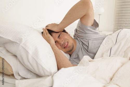 Man waking up with headache