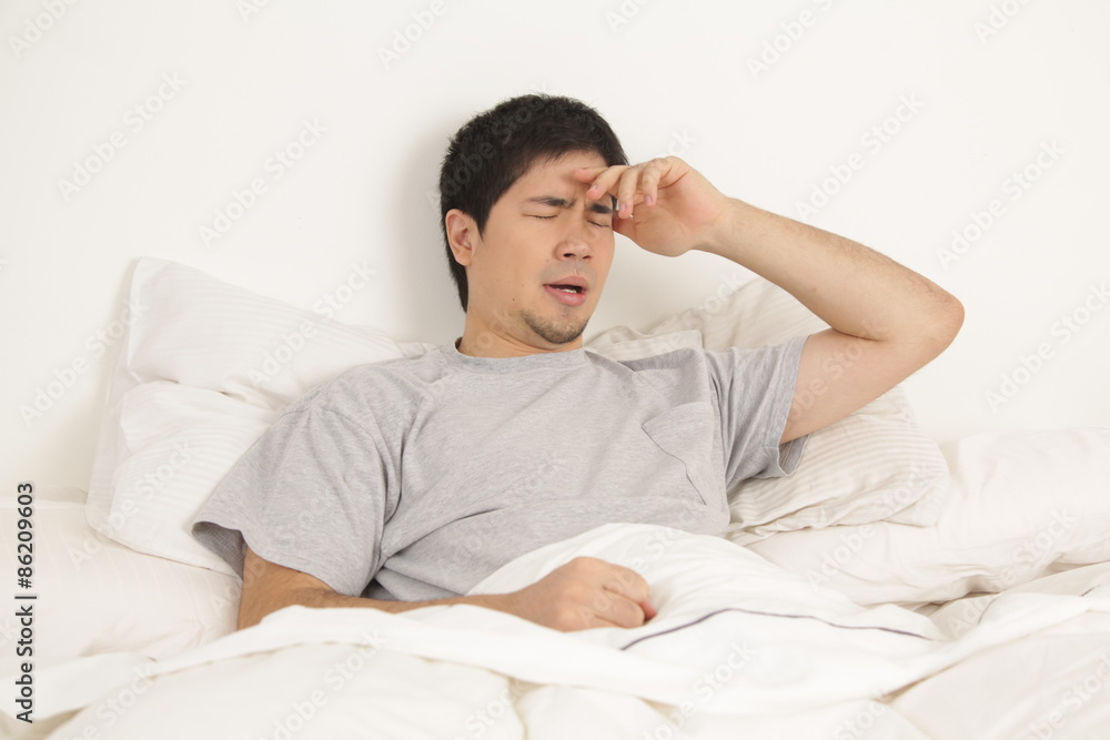 Man lying with headache Man lying with headache