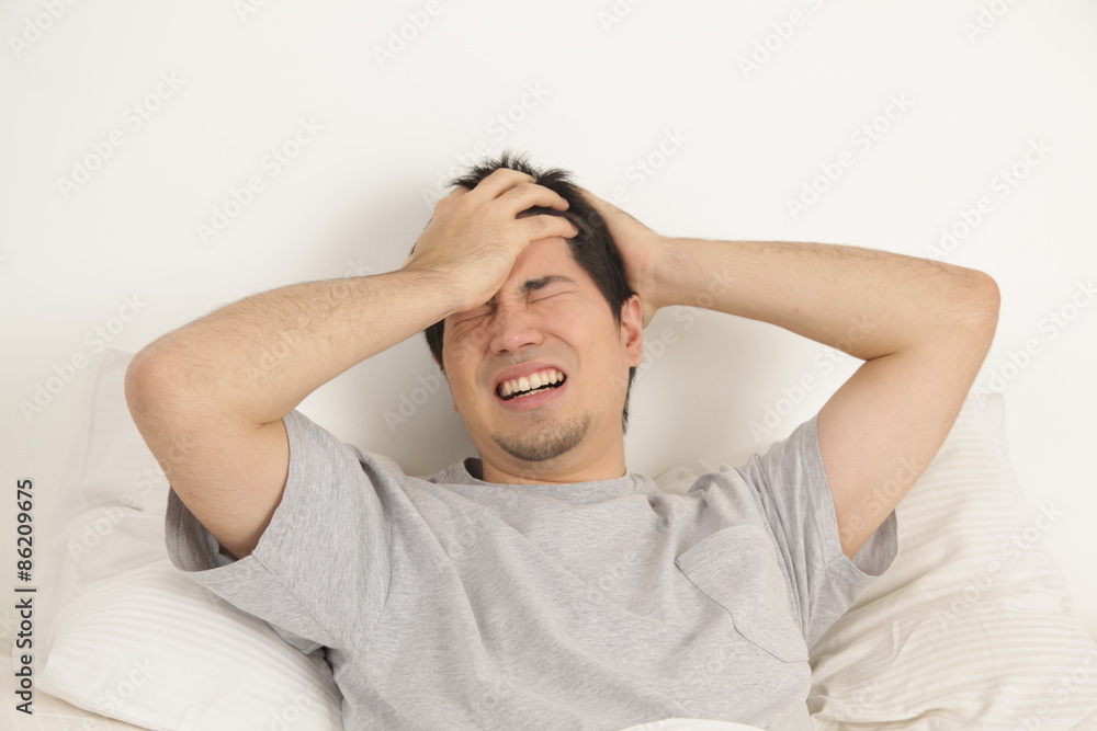 Man lying with headache Man lying with headache
