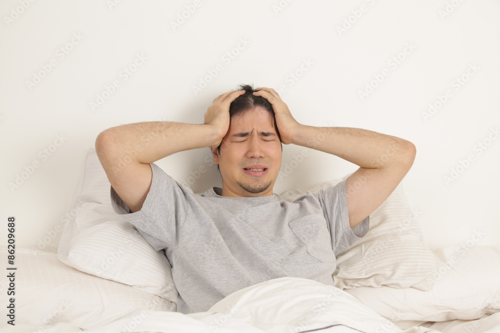 Man lying with headache Man lying with headache