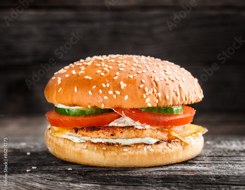 Burger with salmon patty and vegetables