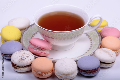 Cup of tea with colorful french macaron