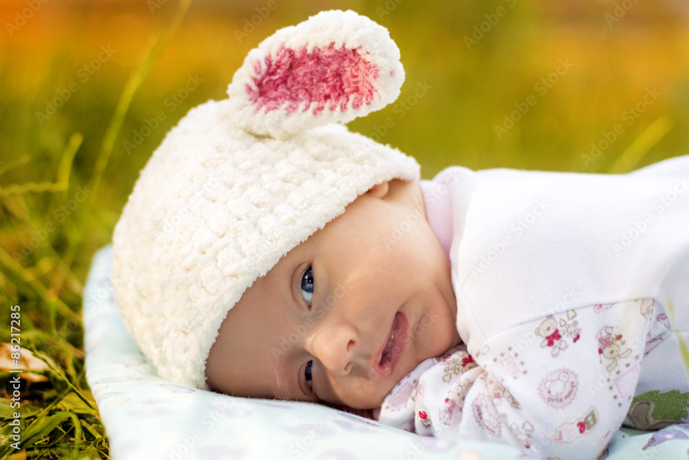 The Baby is lying on the green grass The Baby is lying on the green grass