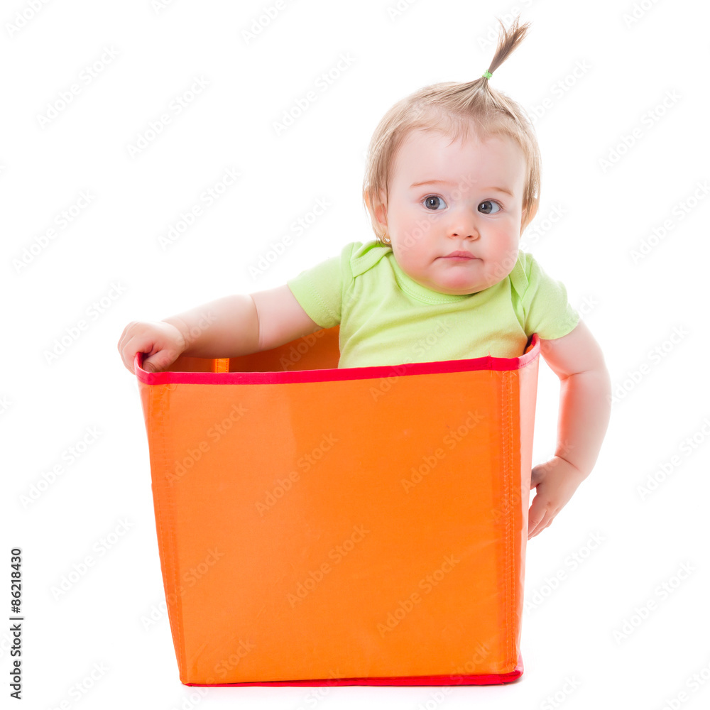 Pensive pretty baby girl sitting in box