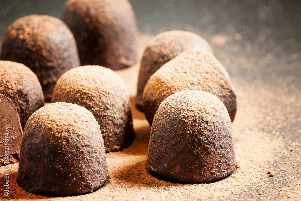 Homemade chocolate truffles with cocoa powder on dark background Homemade chocolate truffles with cocoa powder on dark background