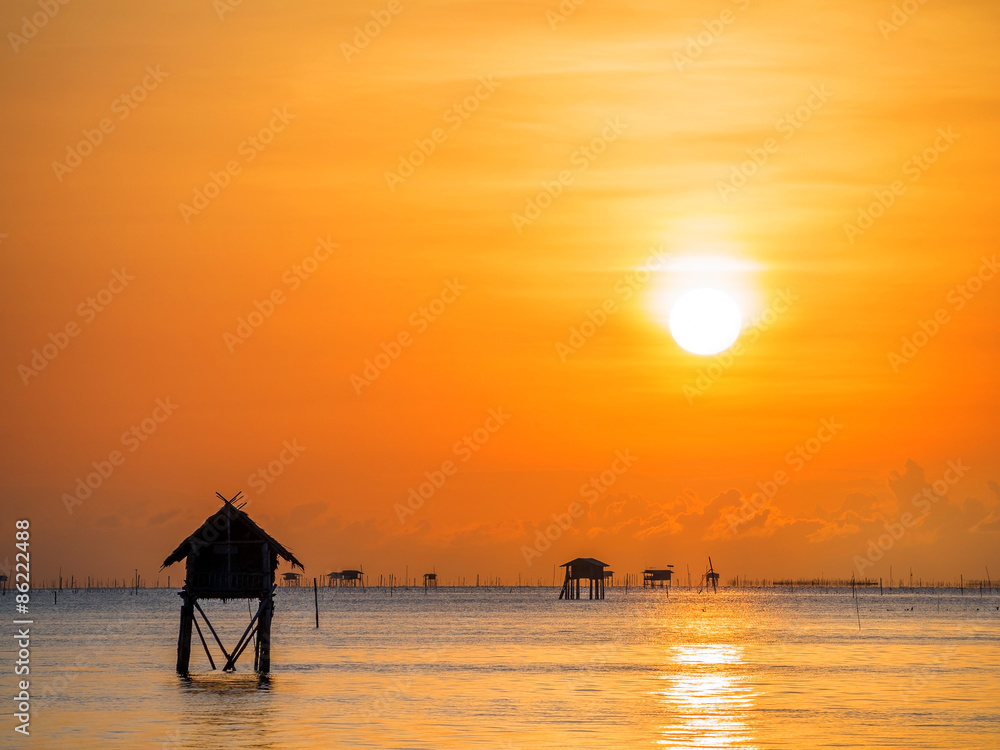 silhouette of fisherman's huts on the sea