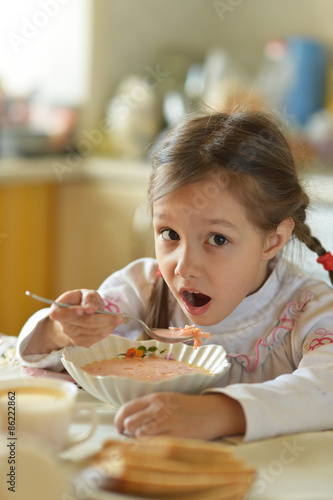 Little girl eating soup