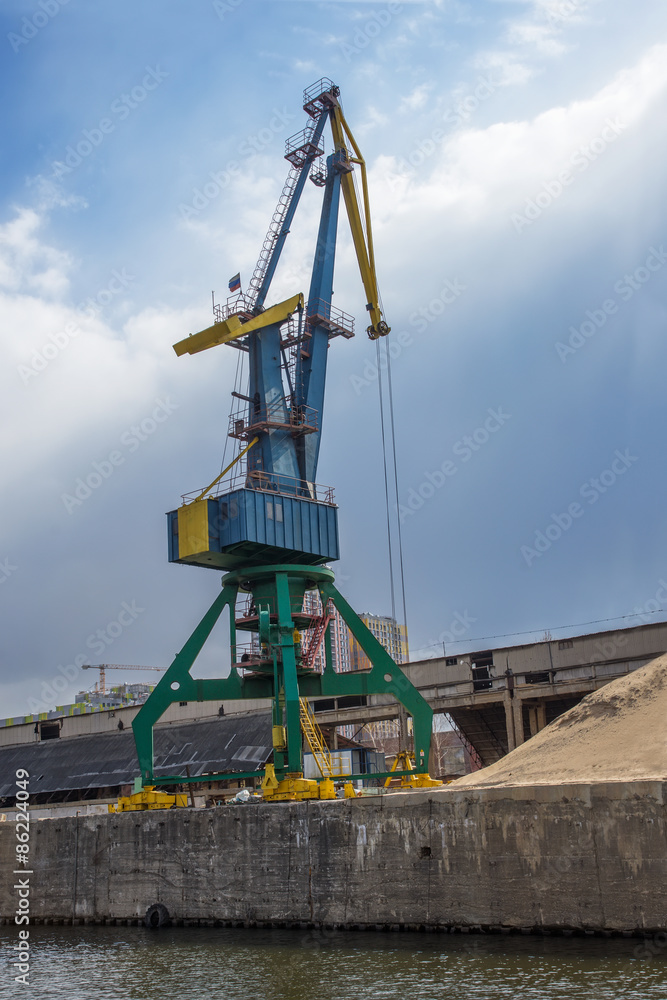 Crane loading cargo in the river port
