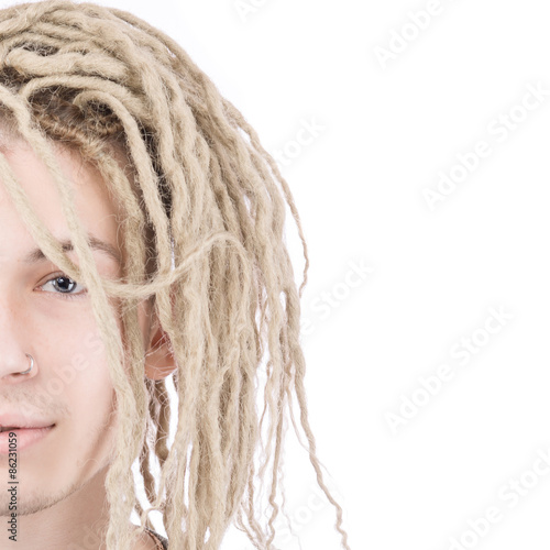 Half face of young adult man with dreadlocks photo