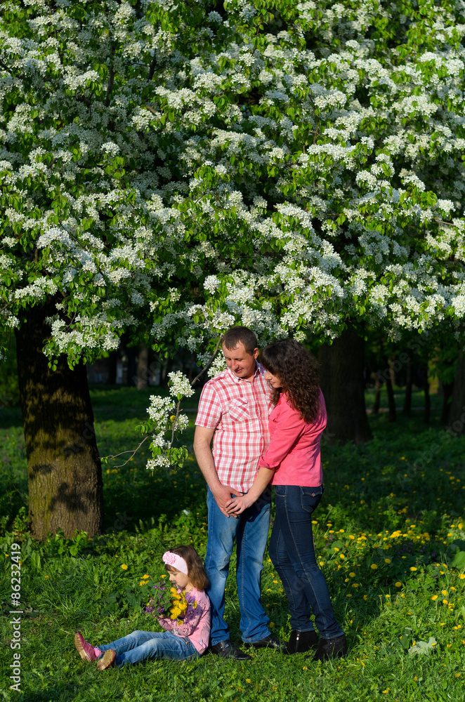 Fototapeta premium family parents and daughter on a walk in a park